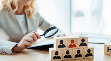selective focus of wooden cubes near blonde recruiter
